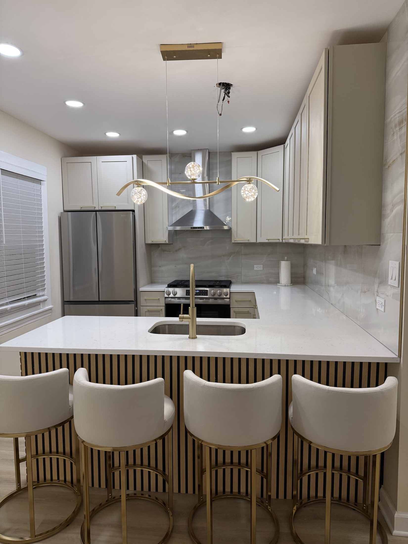 Tailored around the island — Gold & Marble Kitchen by Alpha Handyworks
